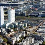 93 Seine-Saint-Denis Paris Region / Saint-Denis: The Pleyel district with the Pleyel Tower / The A86 highway and the Stade de France with the Olympic Aquatics Center in the background / The Grand Paris Express station “Saint-Denis - Pleyel” (interconnection of lines 14, 15, 16 & 17) in the foreground and on the right of the image Ph.Guignard/air-images.net, Direction de l'Observatoire Territorial / Photographer Philippe GUIGNARD (Air Images)